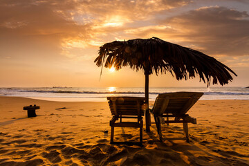 Chaises longues on the beach at sunset. Tropical resort