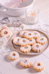 Homemade Christmas cookies with baking ingredients in white