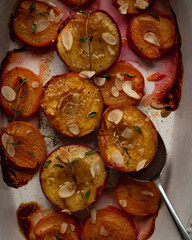 Roasted plums with almond and thyme close up