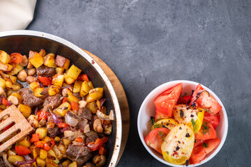 Fried potatoes with mushrooms and beef, top view. Free space.