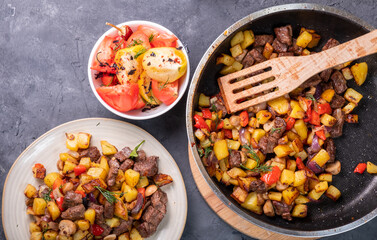 Fried potatoes with mushrooms and beef. View from above.