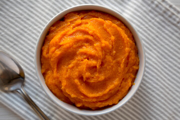 Raw Pumpkin Puree in a Bowl, top view. Flat lay, overhead, from above.