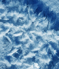 Fototapeta premium Snow crystals form beautiful snow pattern on frozen icy river. Snowflake background.