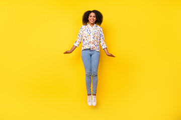 Fototapeta na wymiar Full length photo of sweet young wavy hairdo lady jump wear blouse jeans footwear isolated on yellow background