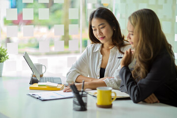 Female business workers are brainstorming and discussing a new business model