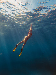 sexy woman swimming underwater in diving mask with flippers