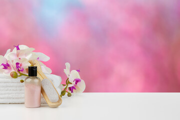 Towels with flowers on light table against blurred background