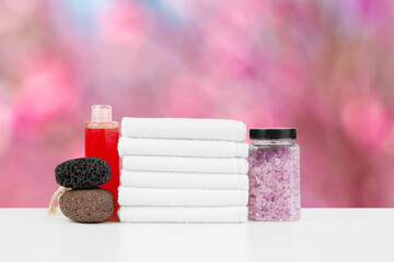 Various spa beauty threatment products and towels against blurred background