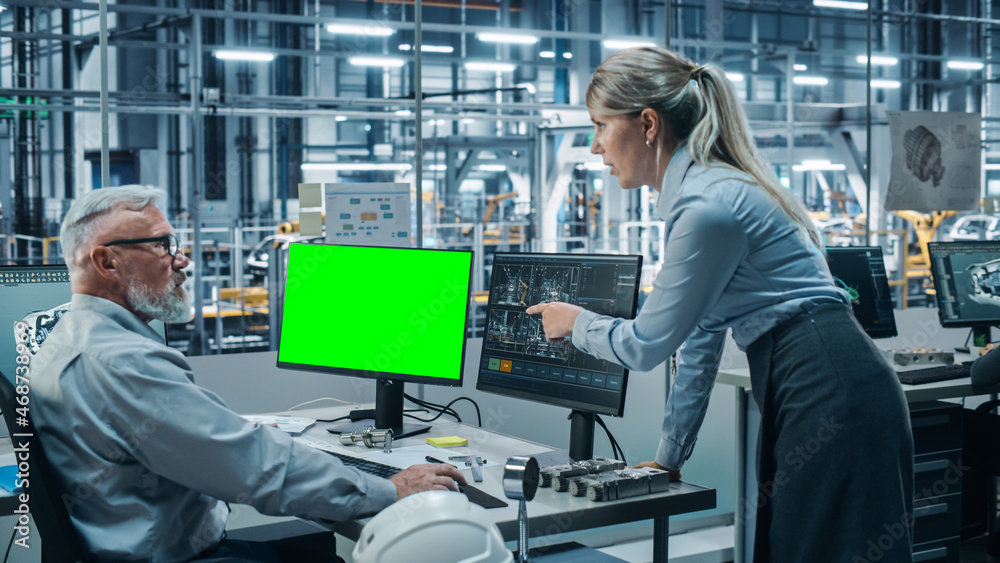 Aufkleber Car Factory Monitoring Office: Female Project Manager Talks to Male Chief Automotive Engineer Working on Green Screen Chroma Key Computer. Automated Robot Arm Assembly Line Manufacturing Vehicles