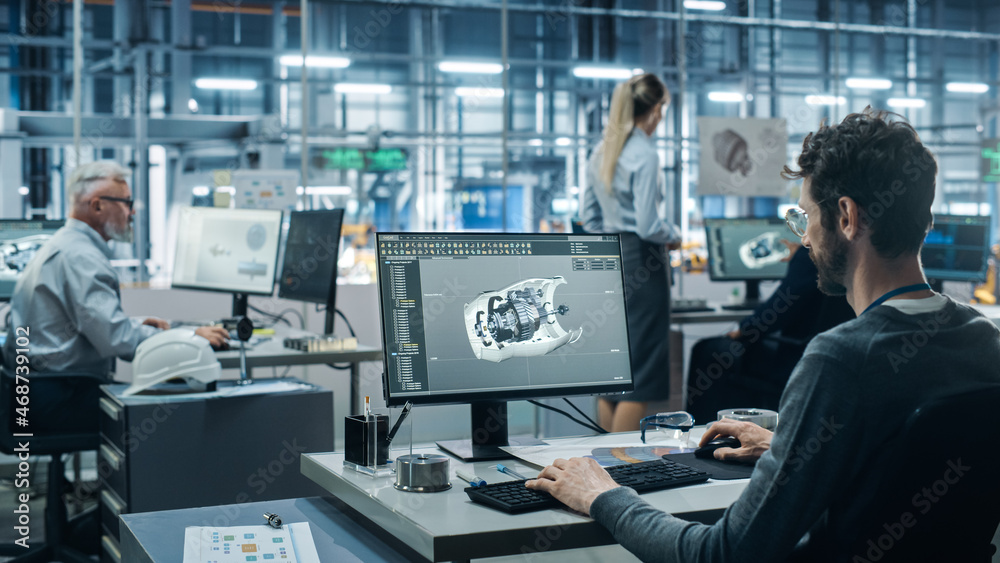 Fototapete Car Factory Office: Engineer Working on Turbine Prototype on Computer, Design Advanced 3D Model for High-Tech Green Energy Electric Engine. Diverse Team Work in Automated Manufacturing Facility