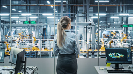 Car Factory Office: Successful Female Chief Engineer Overlooking Factory Production Conveyor....
