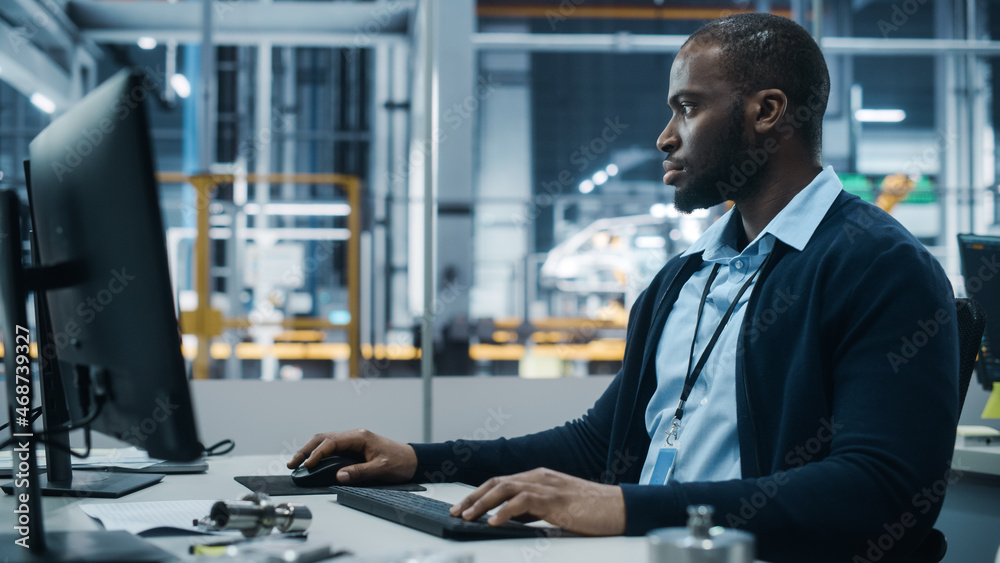 Aufkleber car factory office: portrait of confident black male chief engineer working on desktop computer. pro