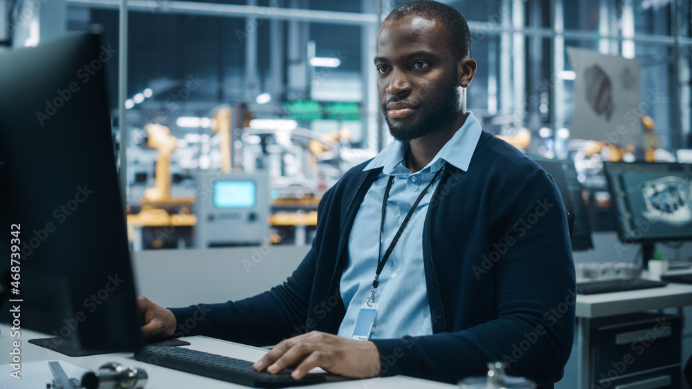 Aufkleber car factory office: portrait of confident black male chief engineer working on desktop computer. pro