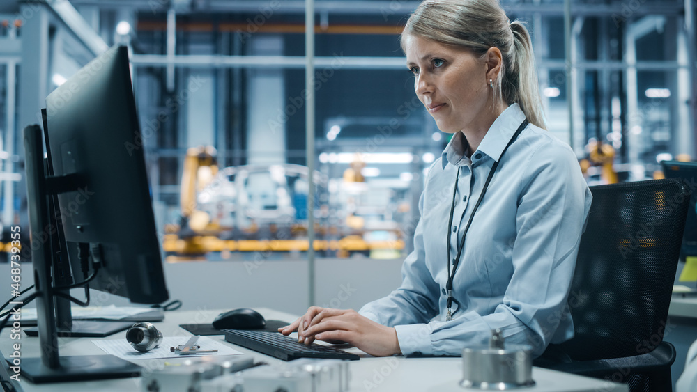 Poster car factory office: portrait of confident female chief engineer working on desktop computer. profess