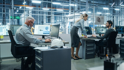 Car Factory Office: Project Manager Talks to Engineer Working on Computer. CAD Software, 3D Turbine...