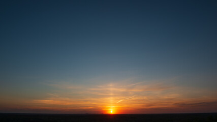 Sunset in rural hilly terrain.