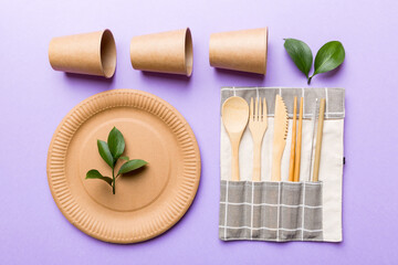 set of empty reusable disposable eco-friendly plates, cups, utensils on light white colored table background. top view. Biodegradable craft dishes. Recycling concept. Close-up