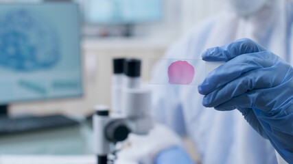 Closeup of scientist chemist doctor holding medical slide analyzing dna sample working at...