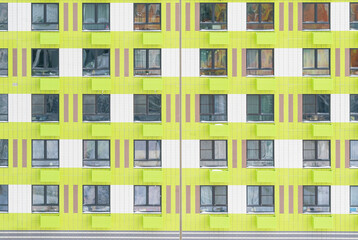 Fototapeta na wymiar green building facade with many windows