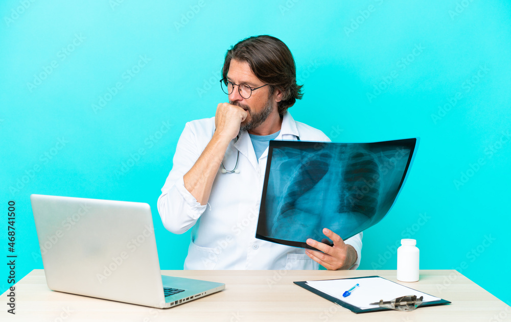 Wall mural professional senior dutch traumatologist in office having doubts