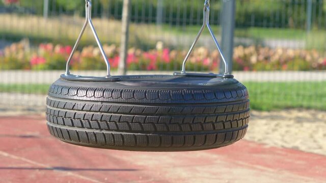 Empty Swing Made Of The Tire In The Park In 4K Slow Motion 60fps