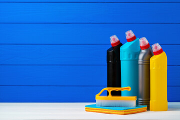 Various cleaning items against blue wooden background