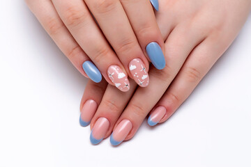 Blue French manicure with painted clouds and crystals on a close-up of long oval nails on a white background. Gel nails.	