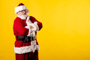 Fototapeta na wymiar Santa Claus with crossed arms on a yellow background