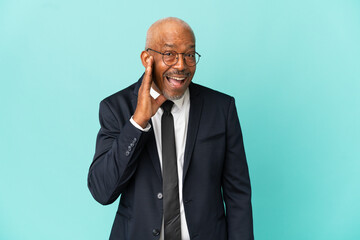 Business senior man isolated on blue background with surprise and shocked facial expression