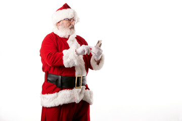 Fototapeta na wymiar Santa Claus using a mobile phone on white background
