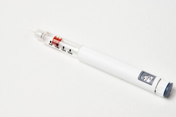 Insulin pen with insulin medicine on white background