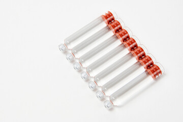Medical vaccine ampoules on white background