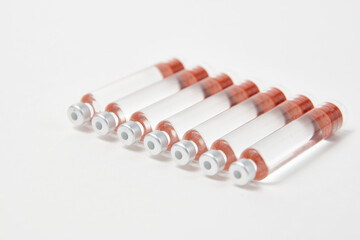 Medical vaccine ampoules on white background