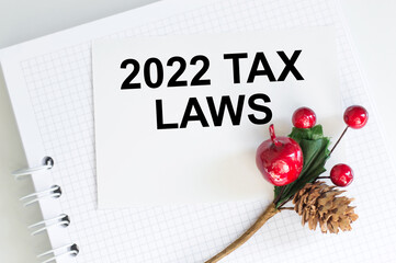 card on a notebook with a message 2022 Tax Laws