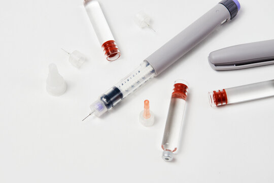 Insulin pen with insulin medicine on white background