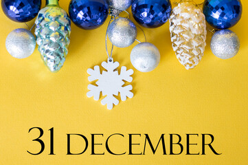 Christmas background with the inscription December 31, on a yellow background Christmas decorations