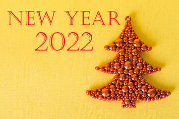 new year 2022 text on the background next to the Christmas tree. Celebration New Year 2022