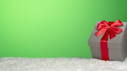 Gift box in artificial snow, color background and copy space