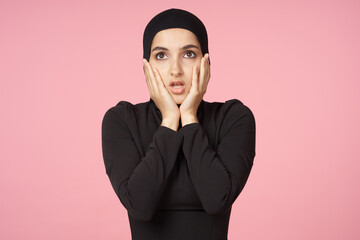 cheerful muslim woman black hijab posing hand gesture pink background