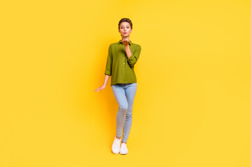 Photo of romantic affectionate lady send air kiss wear green shirt jeans isolated yellow color background