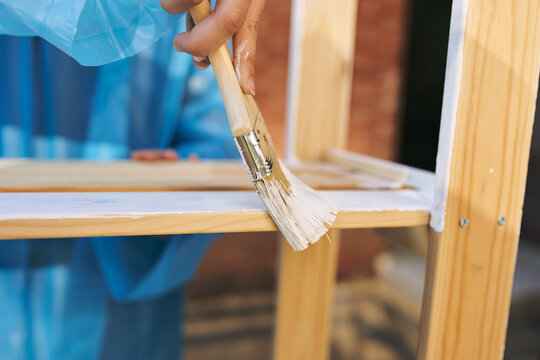 women paint wooden structures brush painter decoration
