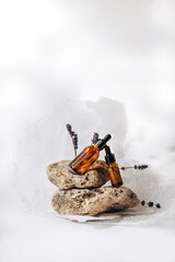 Serum on the podium from a natural stone on a white background. Front view