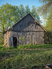 old countryside barn from wooden planks and concrete in rural area