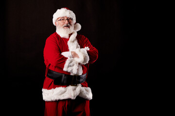 Santa Claus with crossed arms on a black background