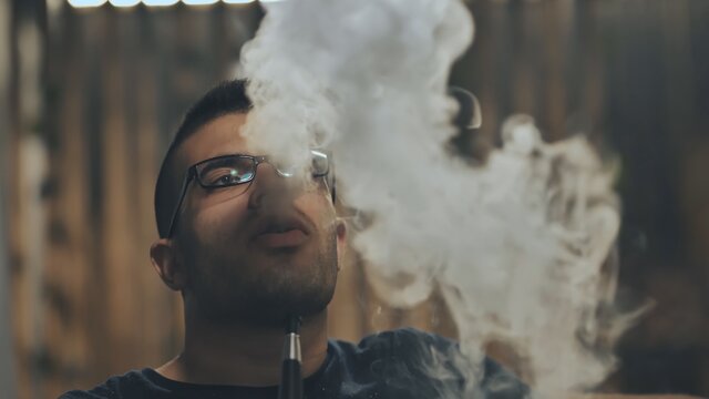 Arabic jordanian young man smokes a hookah.