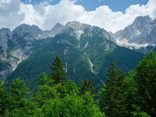 Fototapeta premium summer mountain tops and peaks under blue cloudy sky in Slovenia national Triglav park