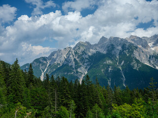 Obraz premium summer mountain tops and peaks under blue cloudy sky in Slovenia national Triglav park