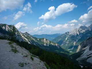 Naklejka na ściany i meble summer mountain tops and peaks under blue cloudy sky in Slovenia national Triglav park