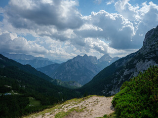 Fototapeta premium summer mountain tops and peaks under blue cloudy sky in Slovenia national Triglav park