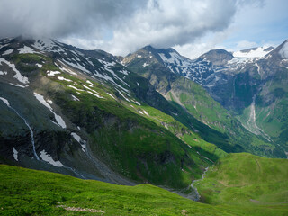 summer green Alps mountains in Austria with snowy peaks